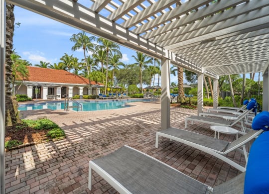 View of the pool from under the pergola at Windsor Coral Springs, Coral Springs, FL