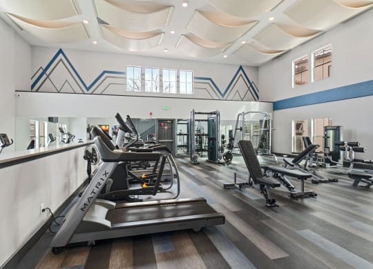Gym with treadmills and other exercise equipment in a building with large windows at Windsor Westminster, Westminster, Colorado