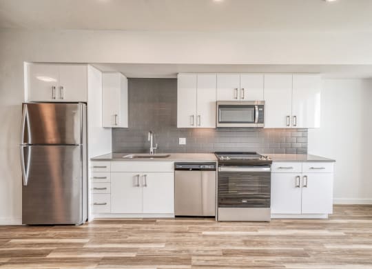 Kitchen with white cabinets and stainless steel appliances  at Windsor Buckman, Portland, Oregon