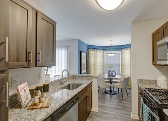 Kitchen with granite countertops and nearby dining room at Windsor Kingstowne, Alexandria, Virginia