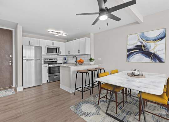 A modern kitchen with a dining table and chairs.