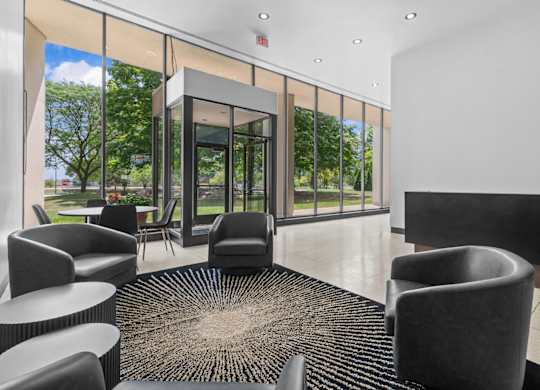 A black and white image of a waiting area with a glass door.