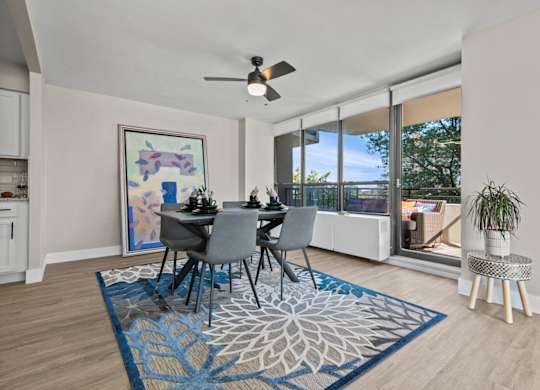 A dining room with a table set for four.