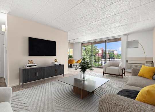 A living room with a flat screen TV mounted on the wall.