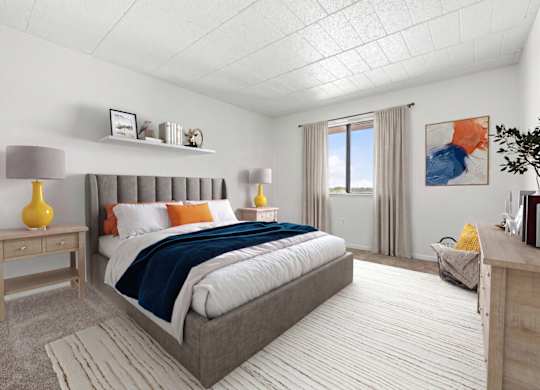 A bedroom with a large bed and a window with curtains.