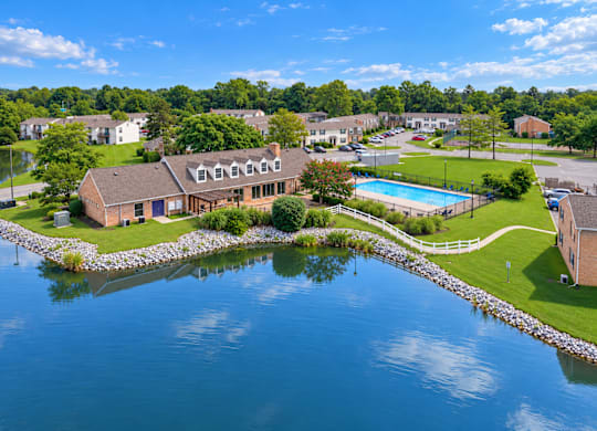 A house is surrounded by water and has a pool.