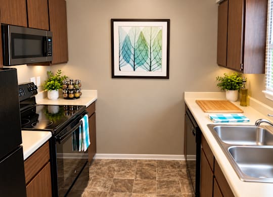 A kitchen with a framed artwork on the wall.