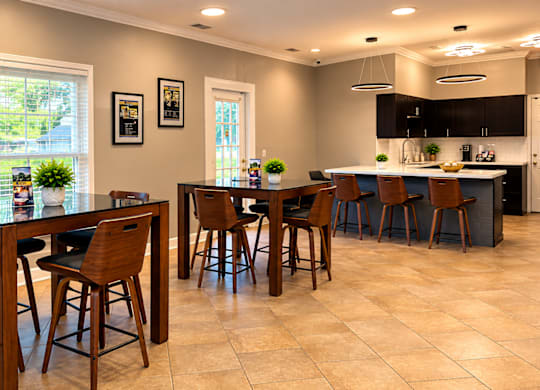 A kitchen with a table and chairs in the middle of the room.