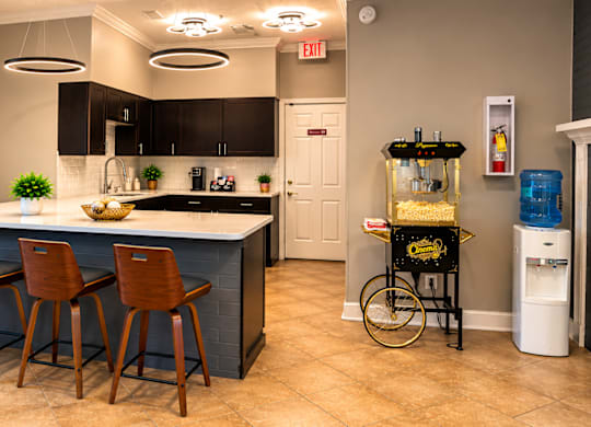 A kitchen with a bar area and a bicycle on display.