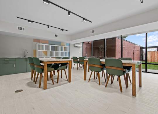 A modern dining room with a wooden table and chairs.