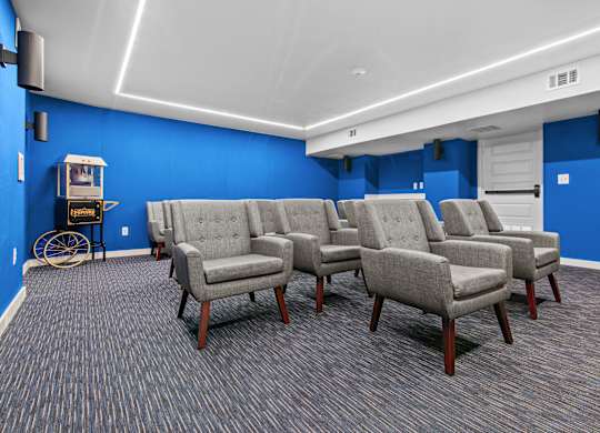 A room with blue walls and grey chairs.