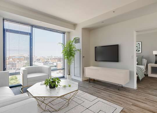 A modern living room with a large window overlooking the city.