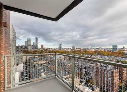 A balcony with a view of a city skyline.