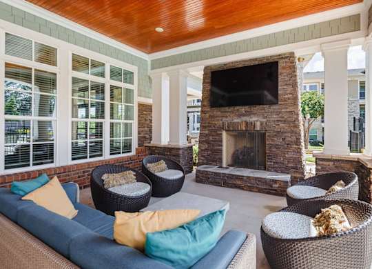 A living room with a fireplace and a television.