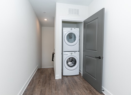 a white washer and dryer in a room with a door