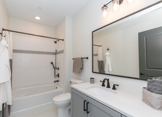 a bathroom with a sink toilet and shower and a mirror