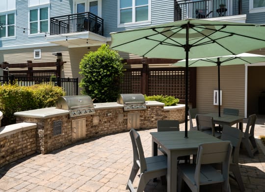 a patio with tables and chairs and umbrellas