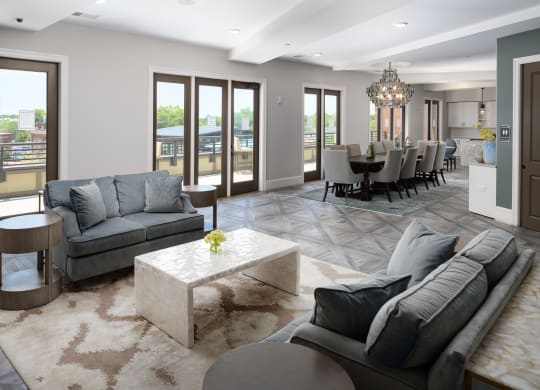 a living room and dining room with couches and a table