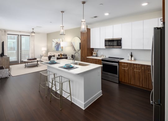 a large kitchen with a center island and stools