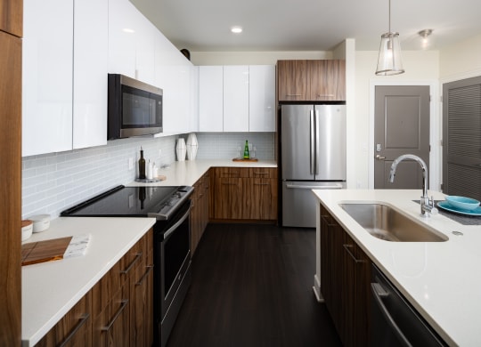 a large kitchen with white counter tops and wooden cabinets