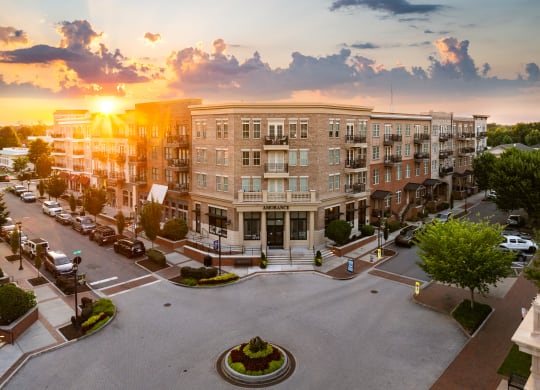 an aerial view of a large apartment building at sunset
