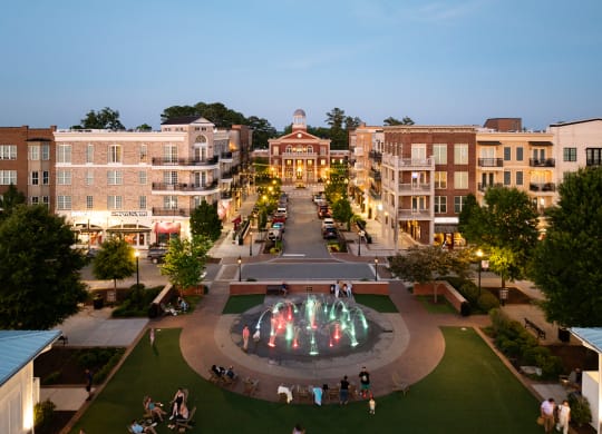 an aerial view of a fountain in the middle of a city square