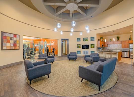 A living room with a circular ceiling and a variety of furniture.