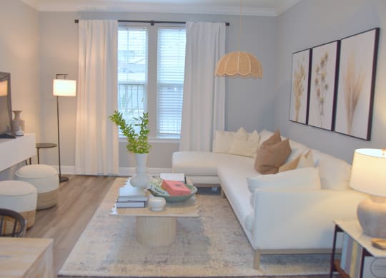 a living room with a white couch and a table