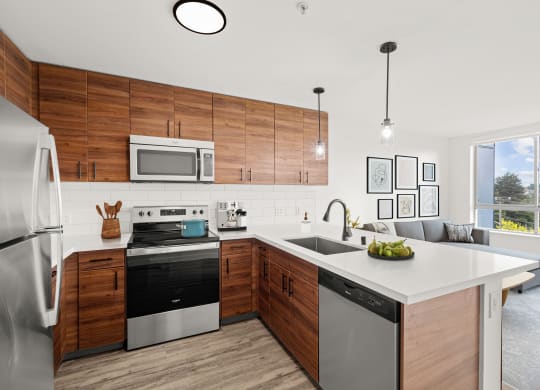 a kitchen with white countertops and wooden cabinets