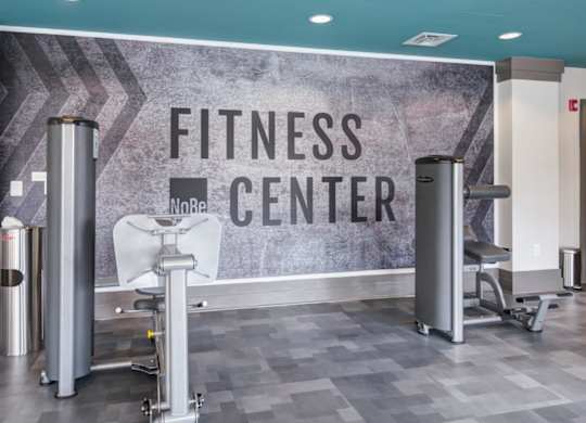 A fitness center with a sign that reads "No Re" and a weight bench.