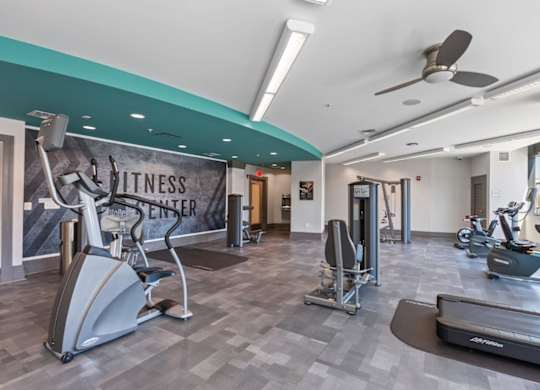 A fitness center with a variety of exercise equipment.