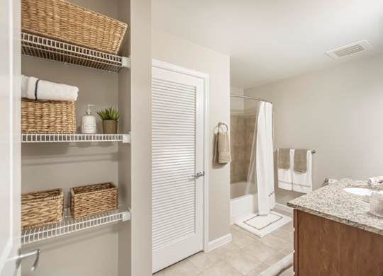 A bathroom with a white door, a white sink, and a white counter.