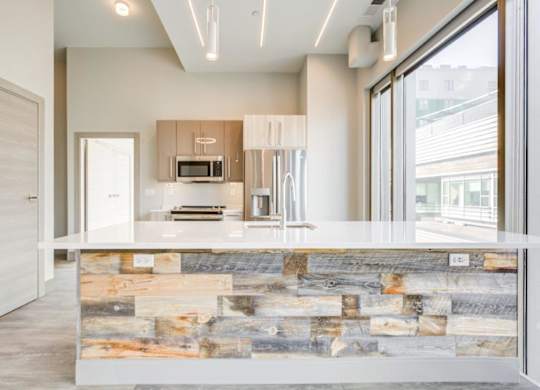 A modern kitchen with a stone counter.