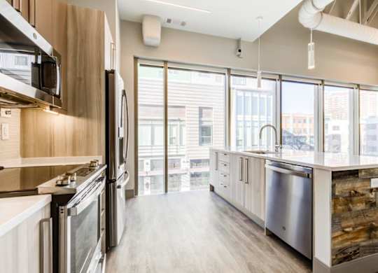 A modern kitchen with stainless steel appliances and wooden accents.