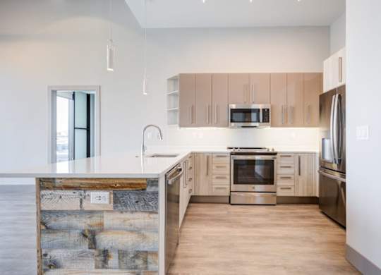 A modern kitchen with wooden cabinets and stainless steel appliances.
