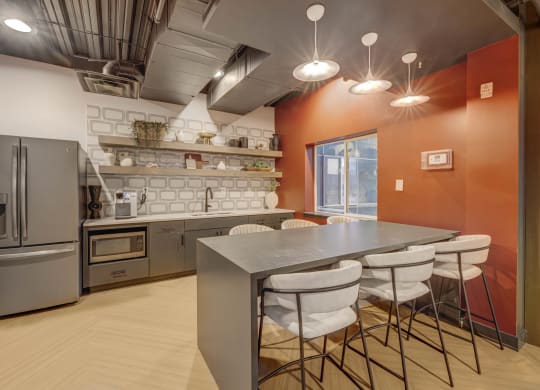 a kitchen with a table and chairs and a refrigerator