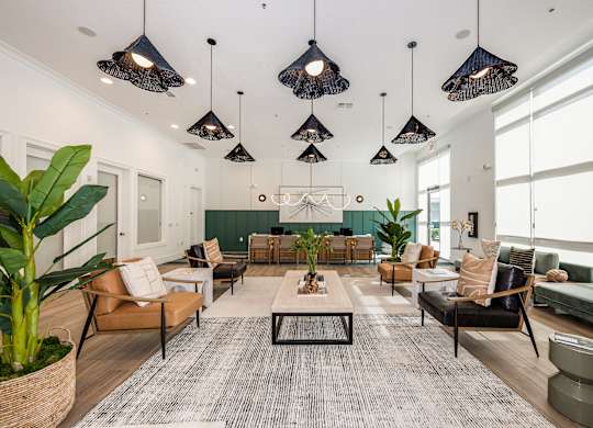 A modern living room with a large rug and a variety of seating options.