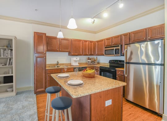 a kitchen with stainless steel appliances and a granite counter top