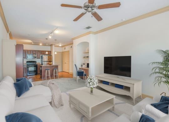 a living room with a white couch and a tv