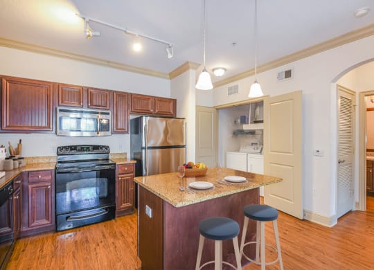 a kitchen with a center island with three stools