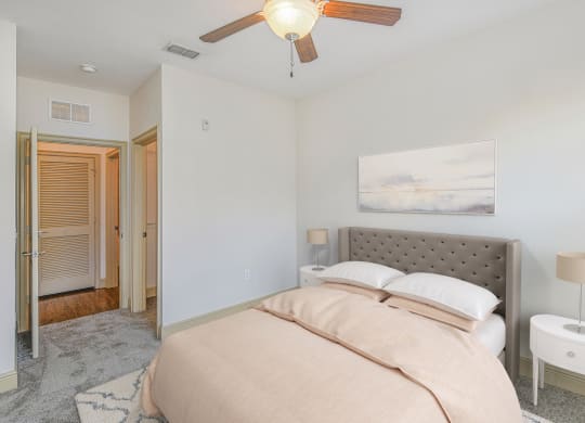 a bedroom with a bed and a ceiling fan