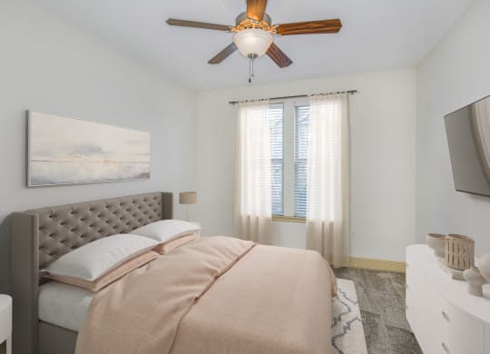 a bedroom with a bed and a ceiling fan