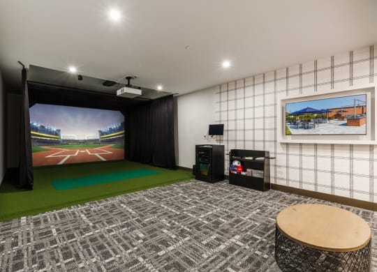 a living room with a large screen tv and a green rug at 100 House Apartments, Jersey City , 07310