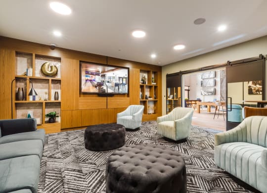 a living room with couches and chairs and a television at 100 House Apartments, Jersey City , NJ
