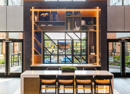 a dining room with a table and chairs in front of a window at 100 House Apartments, Jersey City , New Jersey