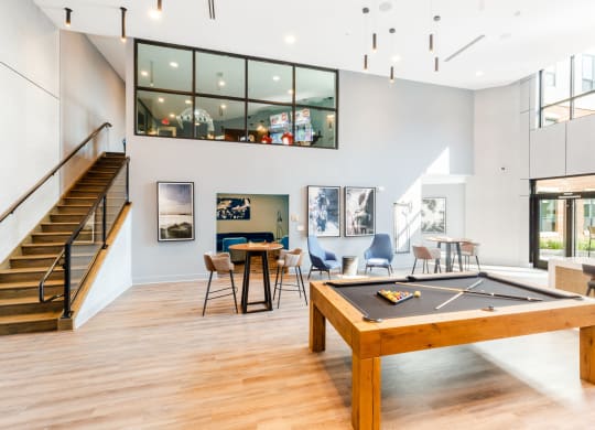 a game room with a pool table and a staircase at 100 House Apartments, Jersey City