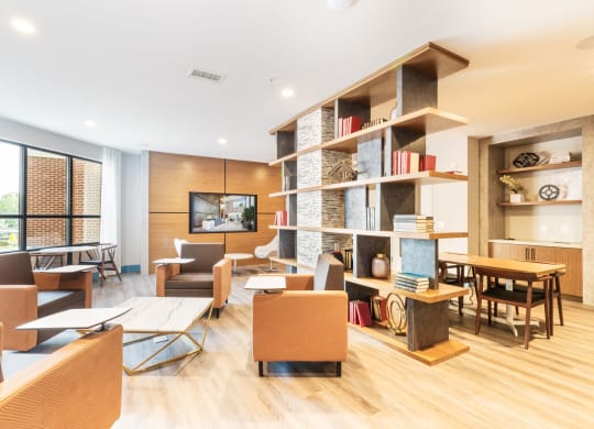 a living room filled with furniture and a book shelf at 100 House Apartments, Jersey City