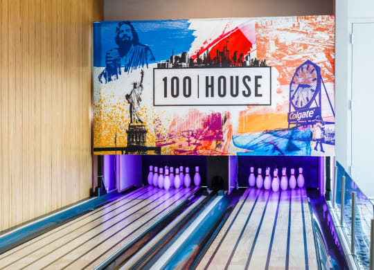 a bowling alley with bowling pins and a sign that reads 100 house at 100 House Apartments, Jersey City , NJ, 07310