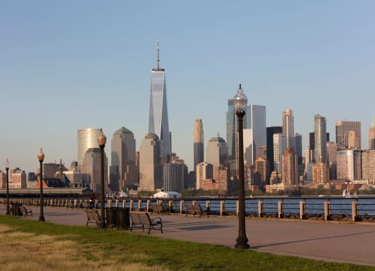 a view of the skyline and the hudson river from a park at 100 House Apartments, Jersey City , NJ, 07310