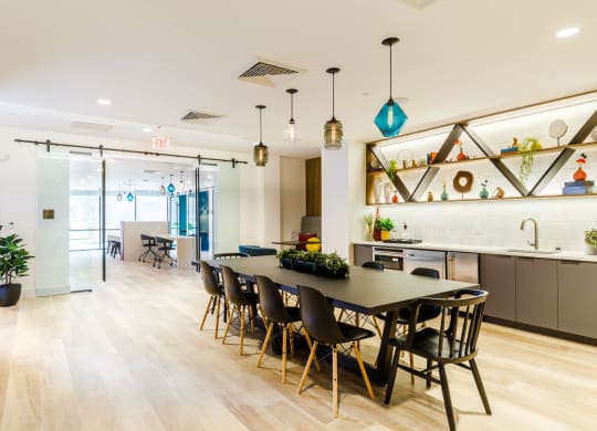 a dining room and kitchen with a table and chairs at One Ten Apartments, New Jersey